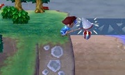 Explotando el globo de un regalo volador con el cazamariposas en Animal Crossing: New Leaf.