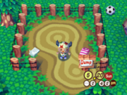 En este vertedero de Animal Crossing: Población: ¡en aumento! se puede ver un papel de carta y una camisa. Detrás se puede ver un Balón