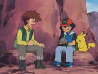 Ash sosteniendo el meteorito con el profesor Cozmo.