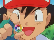 Ash con la medalla Arcoíris.