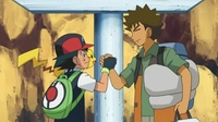 Ash y Brock despidiéndose.