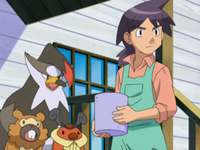Reggie junto a varios Pokémon.